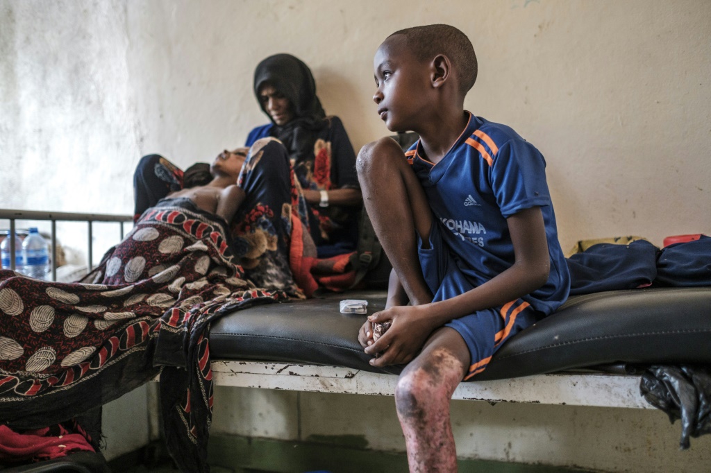 Aicha Nur Cradles Her Wounded Son Tahir. They And Another Son Were Able To Flee But Her Six Other Children Remain Unaccounted For | Afp