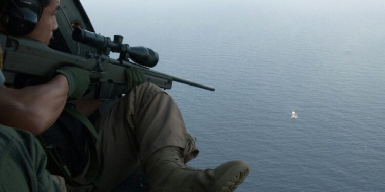 Un Authorization To Fight Piracy In Somali Waters Ends This Undated Handout Photo Released By South Korea'S Military On May 4, 2009 Shows South Korean Soldiers Aboard A Helicopter Aiming A Sniper Rifle At A Pirate Boat After Repelling Its Attack On A North Korean Ship In Waters Off Somalia | Afp