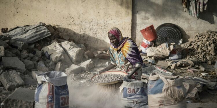 Imf Calls For Restructuring Chad'S Debt A Woman Sifts Gravel From Sand With An Improvised Sieve In N'Djamena, The Capital Of Chad, In April 2021: The Imf Said Chad Needs Debt Restructuring To Help Its Economy | Afp