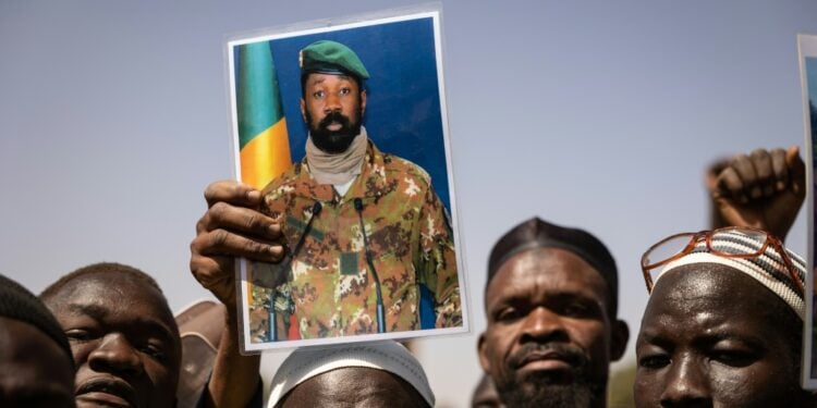 Burkina Urges 'Federation' With Mali For Joint Clout Support: Demonstrators At A Rally In The Burkinabe Capital Ouagadougou In January 2022 Hold Up A Picture Of Malian Junta Leader Colonel Aissimi Goita | Afp