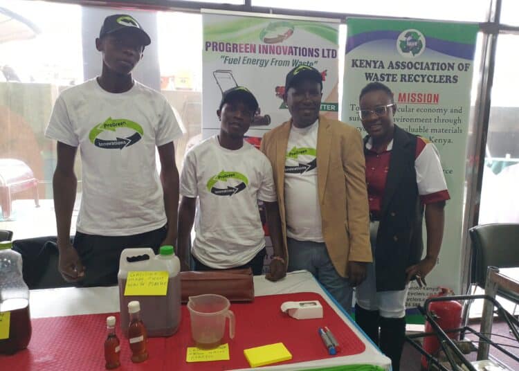 Meet Kenyan Making Petrol And Diesel From Plastic Waste James Muritu, In A Coat, With Colleagues During A Past Forum. Photo/Courtesy.