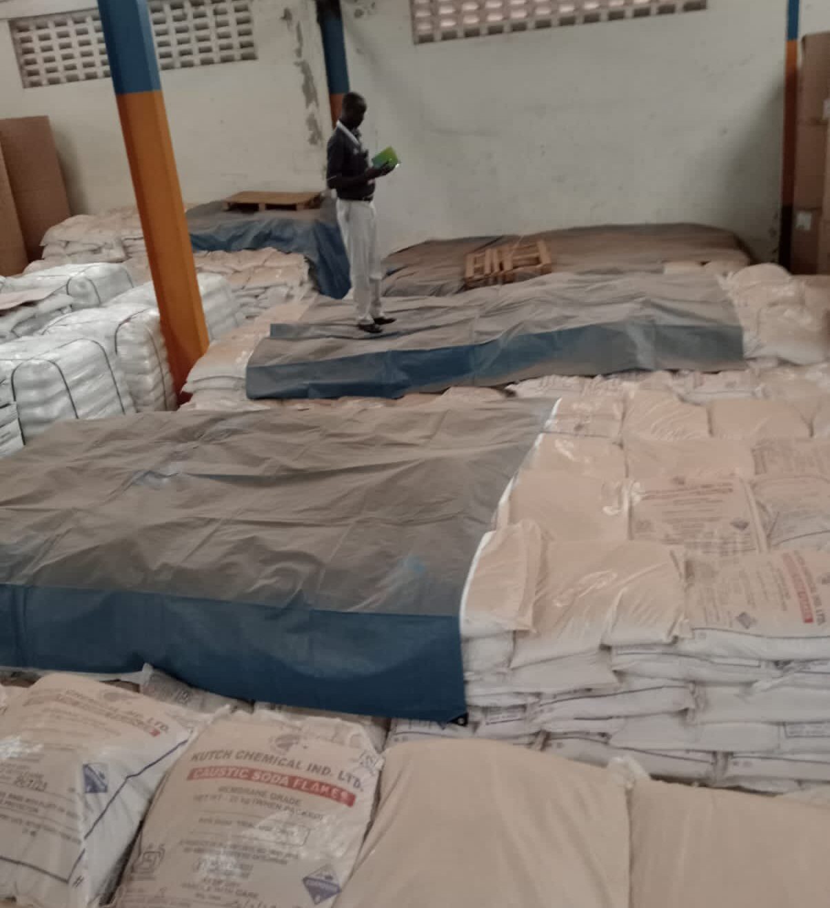Dci Tracks Ksh267 M Shipment Stolen From Indian Tycoon In Uganda Officer Inspecting The Bags Of Caustic Soda At The Liberty Internal Container Depot In Uganda. Photo/Dci.