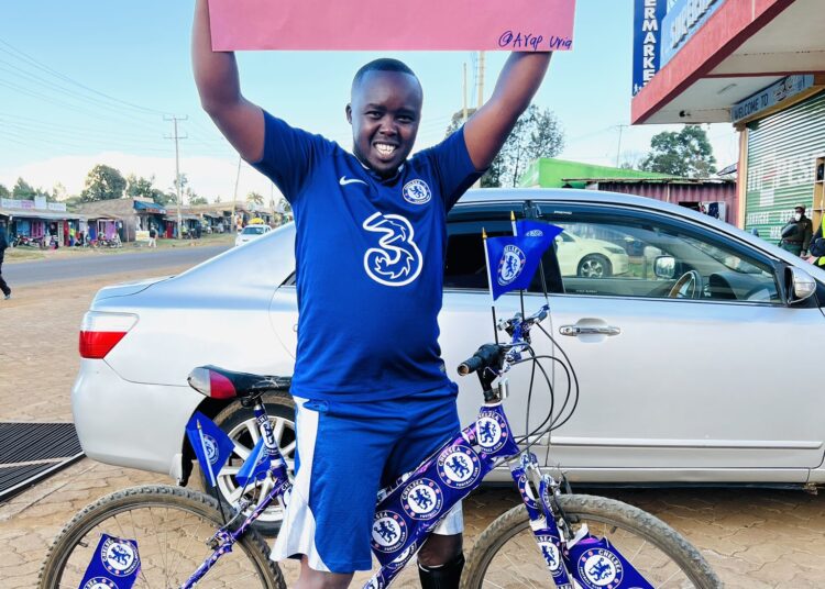 Skit Comedian Arap Uria Poses For A Photo With A Banner In A Past Skit,