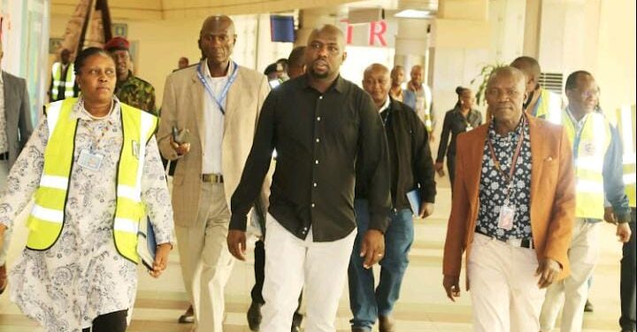 Transport Cs Kipchumba Murkomen (Center) Walks At The Jkia Alongside Other Officials.