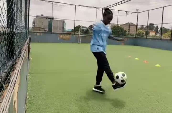 A Kenyan Girl Juggles A Ball At A Pitch In Nairobi'S Kibera Slums. 