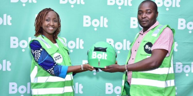 Bolt Cracks Whip, Drops 5,000 Drivers Bolt Country Manager In Kenya Linda Ndungu (Left) Presents A Helmet To A Bolt Boda Boda Rider In The Past.