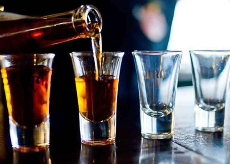 Alcohol Being Poured Into Glasses. Alcohol Being Poured Into Glasses. 