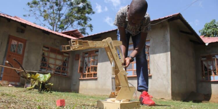 Ethan Simiyu, 14, At His Home Showcasing The Hydraulic Arm. 