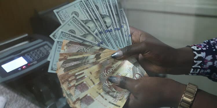 A Cashier At A Nairobi Forex Bureau Counts Dollars And Shilling Notes. Photo/ Courtesy.