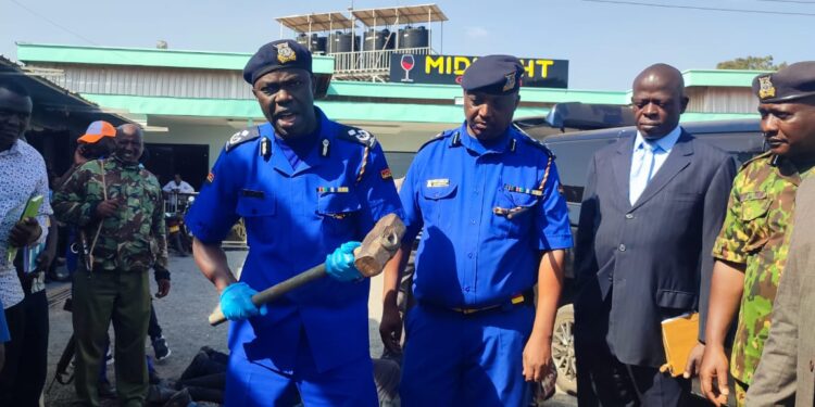 Police Officers Assess The Crude Weapons Recovered From The Robbers Caught At A Night Club In Kimbo, Kiambu County.