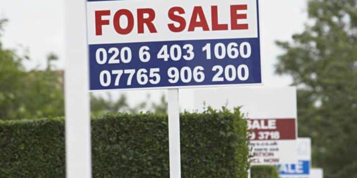 House On Sale Signs Put Up By Estate Agents