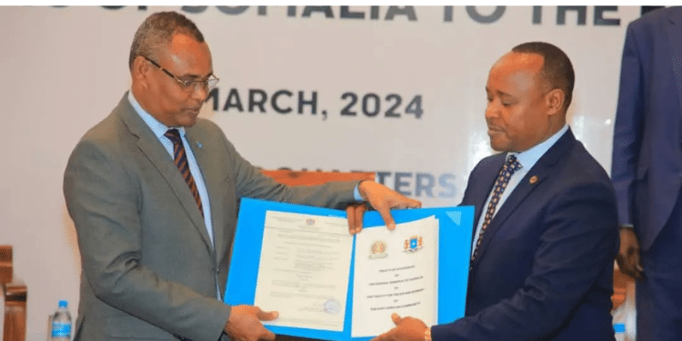 Somalia'S Minister Of Commerce Jibril Abdirashid Haji Abdi (Left) Depositing Her Instrument Of Ratification With Eac Secretary General, Dr Peter Mathuki (Right). Photo/Eac.