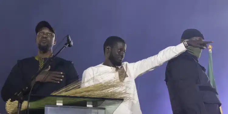 Senegalese Opposition Presidential Candidate Bassirou Diomaye Faye (C) Gestures Next To Senegalese Opposition Leader Ousmane Sonko (L) As They Acknowledge The Crowd Of Supporters Gathering At The Caroline Faye Stadium In Mbour, On March 22, 2024. Photo/ Afp