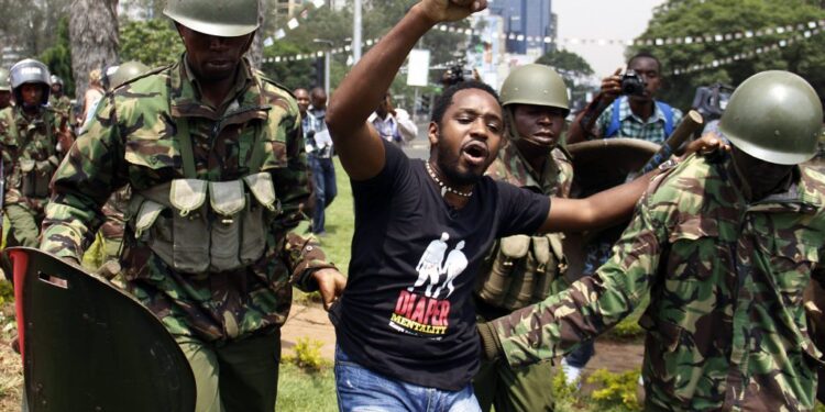 Boniface Mwangi Arrested By A Police Officer At A Past Protest. Photo/ Courtesy
