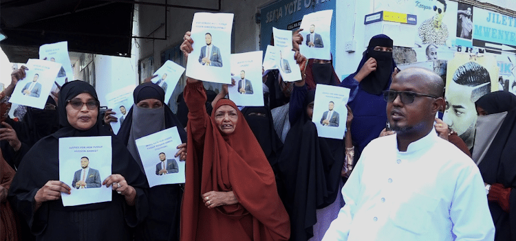 Family Of The Abducted Wajir County Mca Hold Placards In Majengo, Mombasa Urging The Police To Hasten The Probe On The Abduction Of Yusuf Abdi. Photo/ Kna