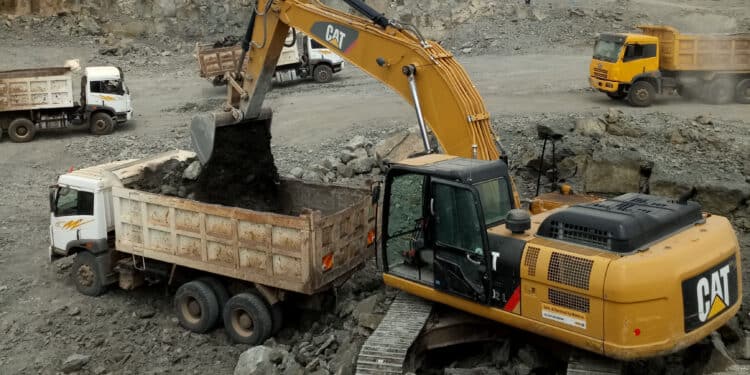A Cat 330D2L Excavator Loading A Dump Truck At Masitima Quarry