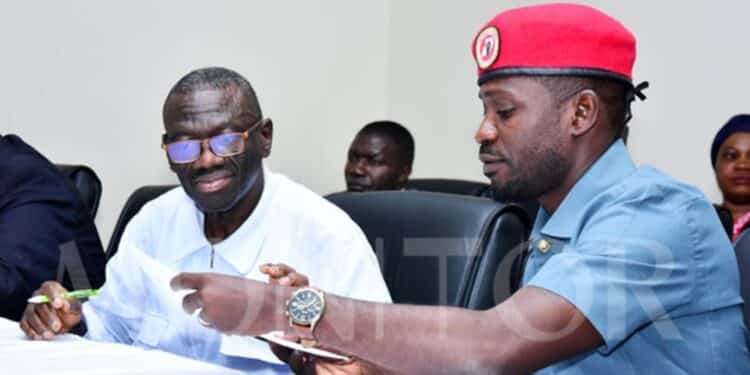 Besigye Goes On Hunger Strike In Prison Nup Party Leader Robert Kyagulanyi, Alias Bobi Wine (Right), Exchanging Documents With The Fdc Founding President, Dr Kizza Besigye, During A Joint Opposition Press Conference In Kampala On August 1, 2022. Photo | Michael Kakumirizi.