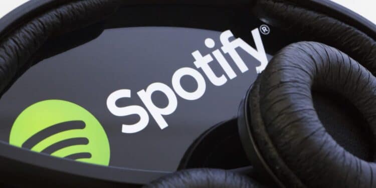A Spotify Logo On Phone And Earphones. 