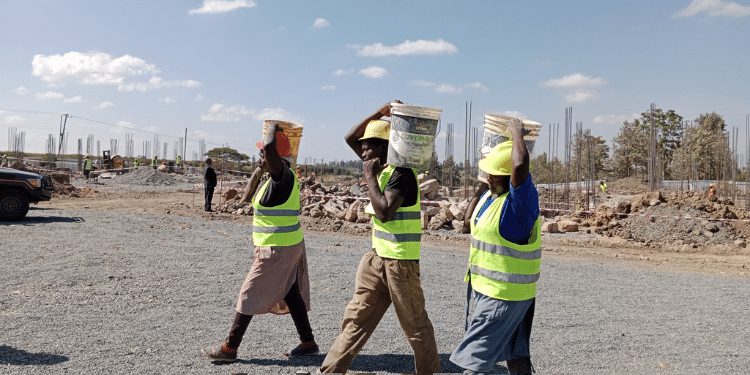 Construction Workers Working At An Affordable Housing Project. 