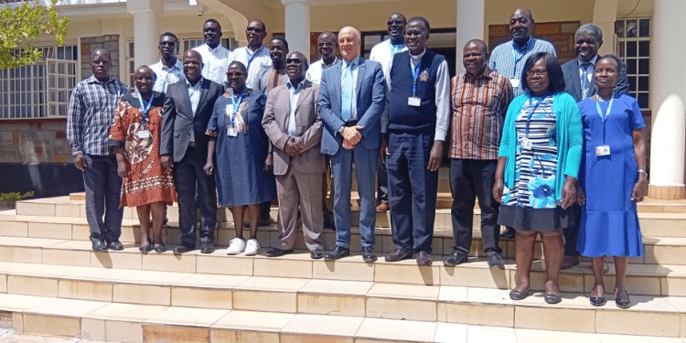 Uzima University Staff Pose For A Photo Outside The Administration Block. Photo/Uzima University. Archbishop Zacchaeus Okoth