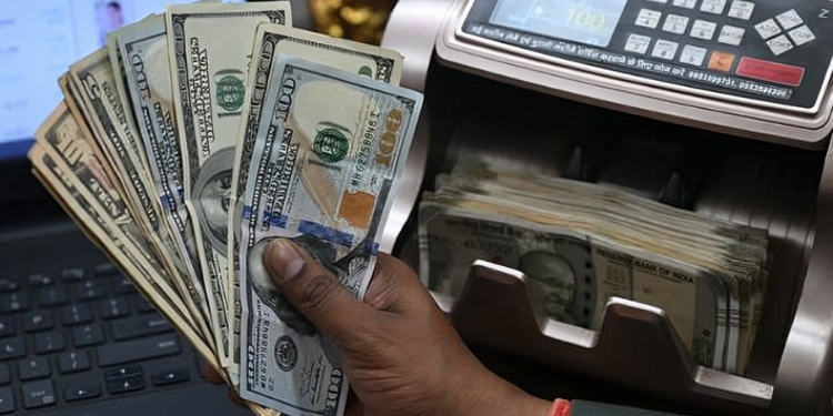 A Cashier At A Bank Handling Dollar Notes Photo/Marketplace