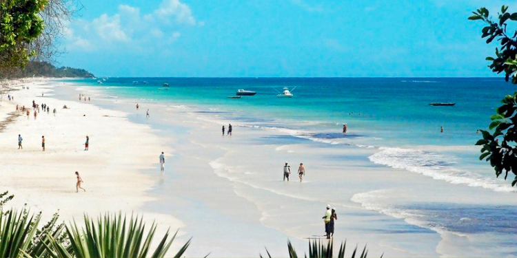 A photo of visitors enjoying the sun and sea at Diani Beach. PHOTO/Diani