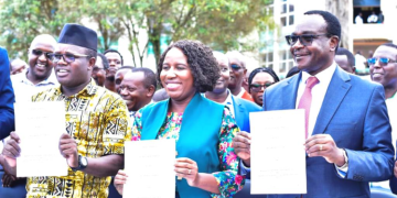 Education Cs Julius Ogamba (Right) And Moi University Union Officials Led By Uasu Secretary General Dr. Constantine Wasonga Display The Signed Agreements To End Their Strike Last Year.